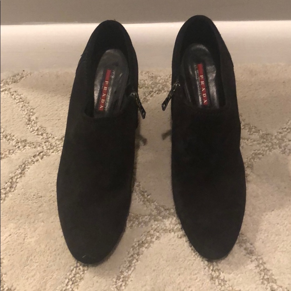Women’s black suede Prada shoe.